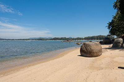 Scenic view of beach against blue sky