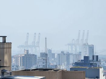 Buildings in city against clear sky