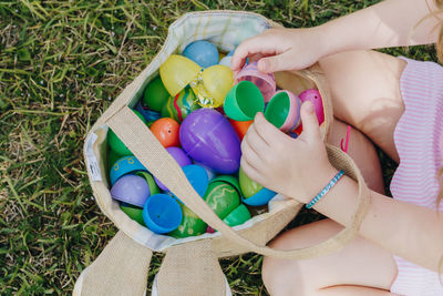 Midsection of girl playing with toys on field