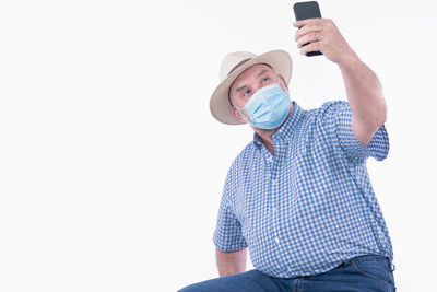 Midsection of man using mobile phone