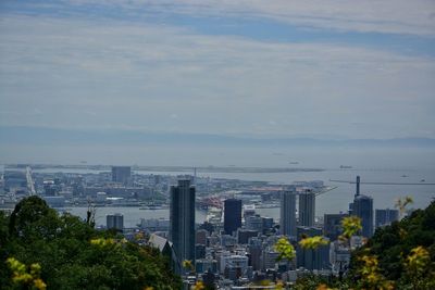 Cityscape against cloudy sky