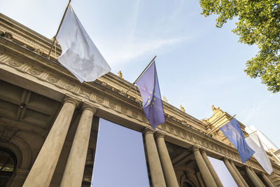 Low angle view of flags against sky