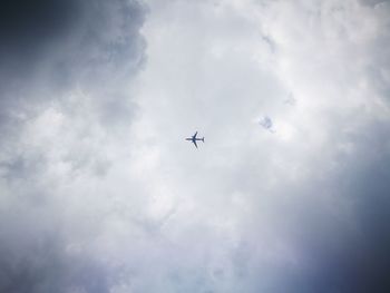 Low angle view of airplane flying in sky