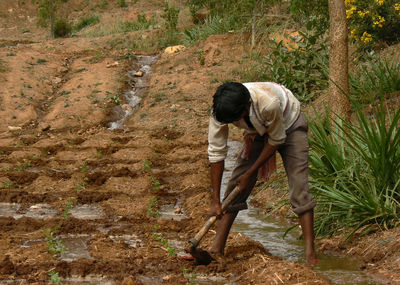 Full length of farmer working on agricultural field