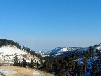 Scenic view of snowcapped mountains against clear sky