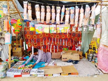 Woman for sale at market stall