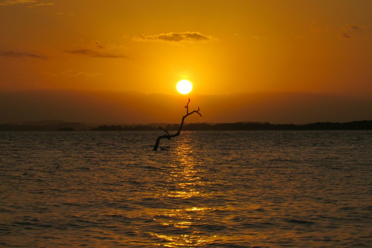 sunset, water, orange color, scenics, sun, beauty in nature, tranquil scene, sea, tranquility, waterfront, silhouette, idyllic, sky, rippled, nature, horizon over water, reflection, outdoors, remote, non-urban scene