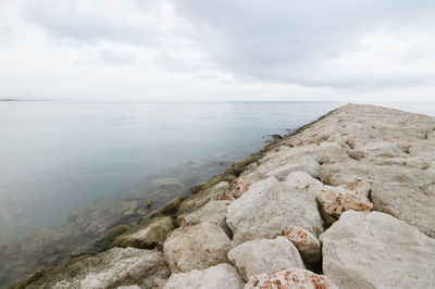 Scenic view of sea against cloudy sky