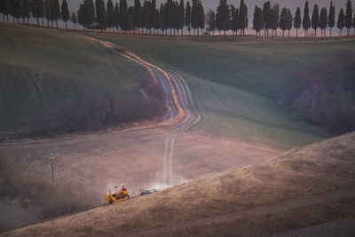 Panoramic view of road passing through field