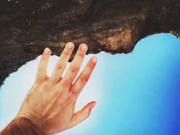 Close-up of hand against clear blue sky