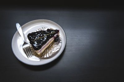 High angle view of cake slice served in plate on table