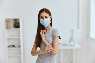 Portrait of beautiful young woman standing at home