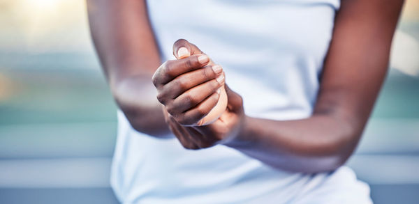 Midsection of woman holding hands