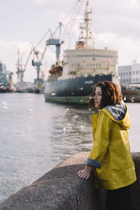 Rear view of woman standing by river