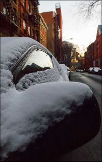 Close-up of snow on road in city