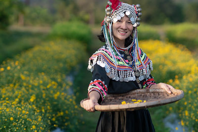 Full length of a smiling woman on field