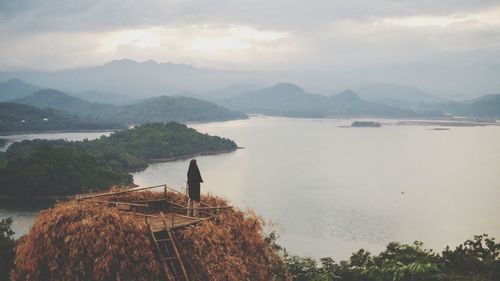 High angle view of sea and mountains against sky