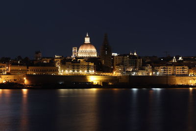 Illuminated buildings in city at night