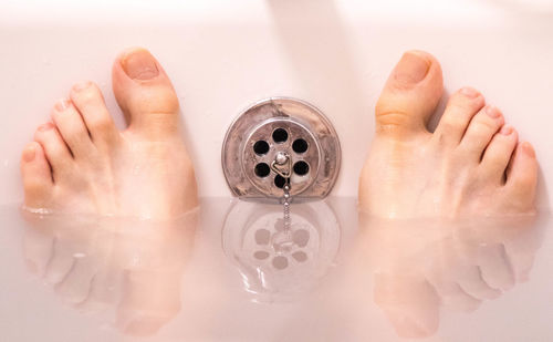 High angle view of person hand in bathroom