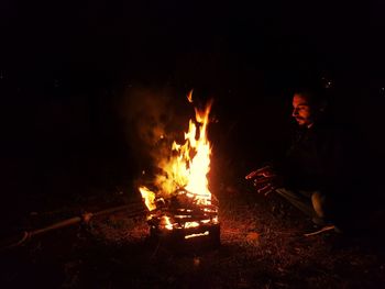 Man around a camping fire in middle of winter 