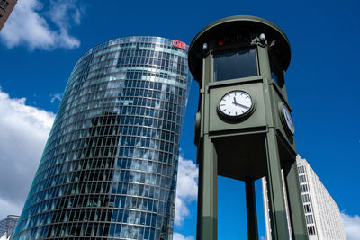 Low angle view of clock tower against blue sky