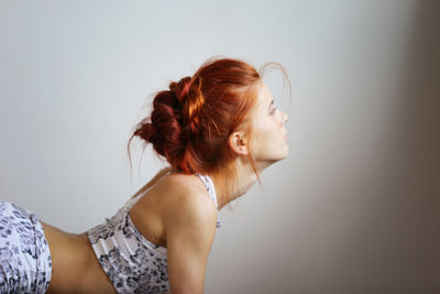 Portrait of young woman against white background