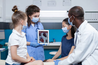 Female doctor examining patient in clinic