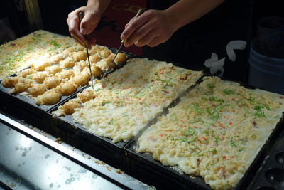 High angle view of person serving food with chopsticks