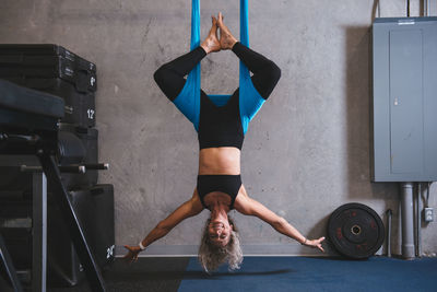 Portrait of smiling woman exercising at gym