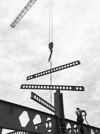 Low angle view of information sign against sky