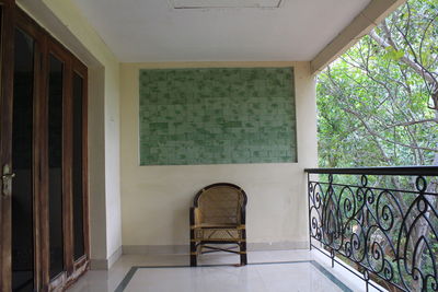 Empty chairs and table against wall at home