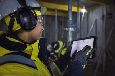 Engineer at building site using digital tablet