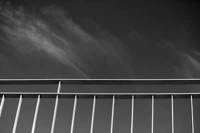 Low angle view of railing against sky