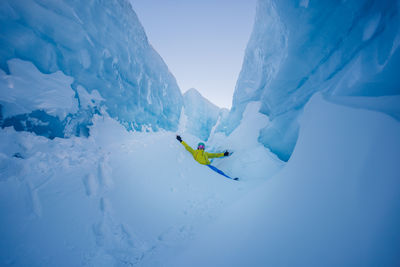 Low angle view of people on snow covered mountain