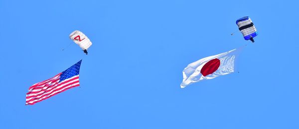 Low angle view of american flag against clear blue sky