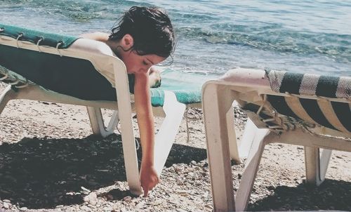 Side view of young woman standing on beach