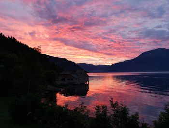 Scenic view of lake against orange sky