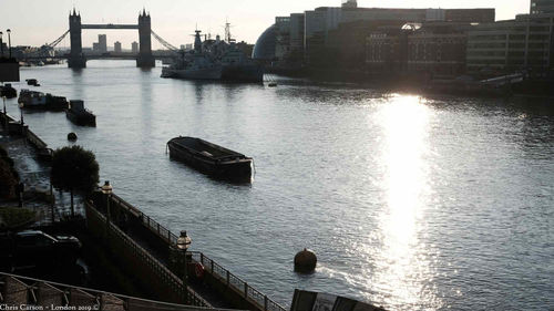 Scenic view of harbor by river against sky