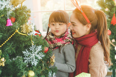 Girl and christmas tree in park during winter