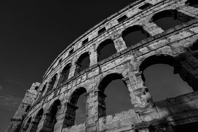 Low angle view of coliseum against sky