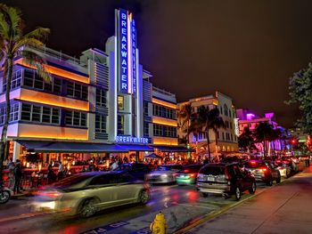 Cars on city street at night