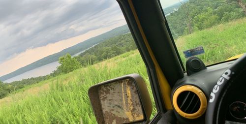 Scenic view of landscape seen through car window