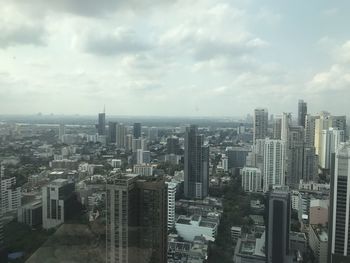 High angle view of modern buildings in city against sky