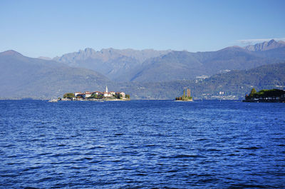 Scenic view of sea and mountains against sky