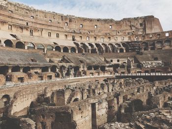 Low angle view of coliseum against sky