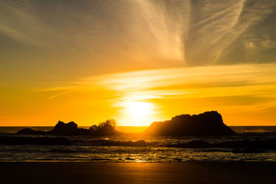 Scenic view of sea against romantic sky at sunset