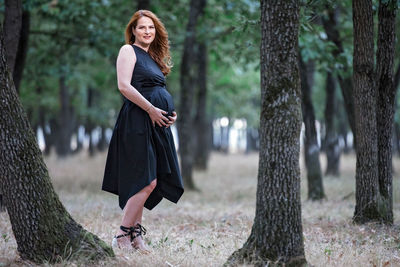 Full length of woman with arms raised