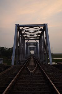 Railway bridge against sky during sunset