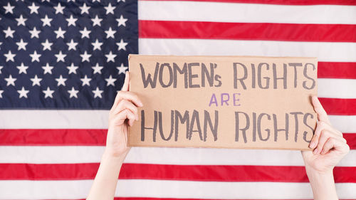 Low section of person holding american flag