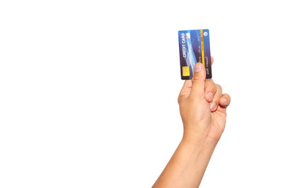 Close-up of hand holding smart phone against white background